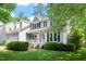 Charming two-story home featuring a manicured lawn, inviting front porch, and an American flag display at 9400 Leslieshire Dr, Raleigh, NC 27615