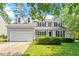 Charming two-story home featuring a manicured lawn, inviting front porch, and a classic American flag display at 9400 Leslieshire Dr, Raleigh, NC 27615