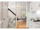 Welcoming foyer with hardwood flooring, staircase, and a glimpse into the living room at 9400 Leslieshire Dr, Raleigh, NC 27615