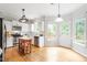Bright kitchen with white cabinetry, stainless appliances, and hardwood floors at 9400 Leslieshire Dr, Raleigh, NC 27615