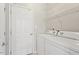 Functional laundry room with washer, dryer, and shelving for organized storage at 9400 Leslieshire Dr, Raleigh, NC 27615