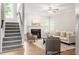 Inviting living room with fireplace, plush seating, hardwood floors, and bright natural light at 9400 Leslieshire Dr, Raleigh, NC 27615