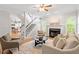 Inviting living room featuring a fireplace, comfortable seating, and staircase access at 9400 Leslieshire Dr, Raleigh, NC 27615