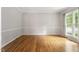 Cozy living room with hardwood floors and natural lighting through a window at 9400 Leslieshire Dr, Raleigh, NC 27615
