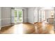 Bright living room features gleaming hardwood floors and large windows with lots of natural light at 9400 Leslieshire Dr, Raleigh, NC 27615