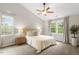 Serene main bedroom featuring natural light, a ceiling fan, and plush carpeting at 9400 Leslieshire Dr, Raleigh, NC 27615
