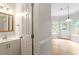 Charming powder room adjacent to a dining area featuring a decorative mirror and modern fixtures at 9400 Leslieshire Dr, Raleigh, NC 27615