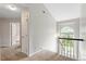 Upstairs hallway with carpet and natural light. Doors lead to other rooms at 9400 Leslieshire Dr, Raleigh, NC 27615