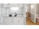 Stylish wet bar featuring granite countertops and ample storage space at 9400 Leslieshire Dr, Raleigh, NC 27615