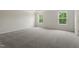 Spacious bedroom with plush carpet and two large windows offering natural light at 95 Cordoba Dr, Franklinton, NC 27525