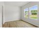 Bright bedroom with wood-look floors and two windows showcasing the landscape at 95 Cordoba Dr, Franklinton, NC 27525