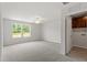 Spacious bedroom adjacent to a laundry room featuring carpet and bright windows at 95 Cordoba Dr, Franklinton, NC 27525