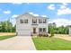 Charming two-story home featuring a well-manicured lawn and an attached two-car garage at 95 Cordoba Dr, Franklinton, NC 27525