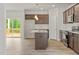 Kitchen features an island, sleek countertops, stainless appliances, and backyard access at 95 Cordoba Dr, Franklinton, NC 27525