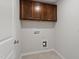 Laundry room featuring upper cabinets, tile floors, and utility connections at 95 Cordoba Dr, Franklinton, NC 27525