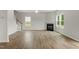 Spacious living room features a fireplace, staircase, bright windows, and luxury vinyl floors at 95 Cordoba Dr, Franklinton, NC 27525