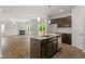 Open-concept living space featuring luxury vinyl flooring, a kitchen island, and a cozy fireplace at 95 Cordoba Dr, Franklinton, NC 27525