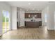 Open-concept living space features luxury vinyl flooring, a kitchen island, and sliding glass doors at 95 Cordoba Dr, Franklinton, NC 27525