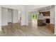 Open-concept living space featuring luxury vinyl flooring, a kitchen island, and sliding glass doors at 95 Cordoba Dr, Franklinton, NC 27525