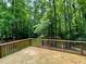 Picture of the back deck overlooking a tranquil wooded area at 96 Holly Cir, Henderson, NC 27537
