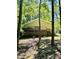 Exterior view of a home with a wooden deck with stairs to the backyard surrounded by woods at 96 Holly Cir, Henderson, NC 27537