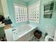Bright bathroom with a jetted tub and unique glass block windows for natural light at 96 Holly Cir, Henderson, NC 27537