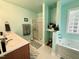 Bathroom featuring a glass enclosed shower, double sink vanity, and jacuzzi tub at 96 Holly Cir, Henderson, NC 27537