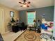 Bedroom with a ceiling fan and an office space next to the window at 96 Holly Cir, Henderson, NC 27537
