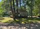 Carport featuring a white van and boat, surrounded by trees at 96 Holly Cir, Henderson, NC 27537