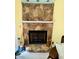Cozy living room fireplace with stonework and a white mantle at 96 Holly Cir, Henderson, NC 27537