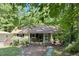 Charming single-story home with a welcoming front porch and lush, mature landscaping surrounded by trees at 96 Holly Cir, Henderson, NC 27537