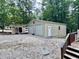 Large detached two-car garage with ample storage space and a workshop area at 96 Holly Cir, Henderson, NC 27537