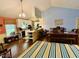 Open-concept kitchen boasts stainless steel appliances, breakfast bar, and hardwood floors at 96 Holly Cir, Henderson, NC 27537