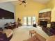 Spacious living room features stone fireplace, ceiling fan, and French doors to the exterior at 96 Holly Cir, Henderson, NC 27537