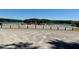 Gravel parking lot with vehicles and trailers parked near the lake at 96 Holly Cir, Henderson, NC 27537