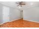 A simple bedroom featuring light gray walls, wood floors, and a ceiling fan for a clean and neutral space at 1002 Kingswood Dr # A, Chapel Hill, NC 27517