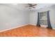 Empty bedroom with hardwood floors, ceiling fan and window with neutral colored curtains at 1002 Kingswood Dr # A, Chapel Hill, NC 27517