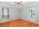 A bright bedroom with two large windows, hardwood floors, light walls and ceiling fan for comfort at 1002 Kingswood Dr # A, Chapel Hill, NC 27517