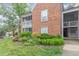 Charming brick condo featuring a cozy balcony and well-maintained landscaping at 1002 Kingswood Dr # A, Chapel Hill, NC 27517