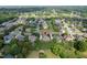Aerial view of a mature residential area with homes surrounded by lush trees and well-kept lawns at 1010 Mill Pointe Way, Elon, NC 27244