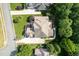 Aerial view of the home shows backyard greenery, a patio, and the roof's architecture at 1010 Mill Pointe Way, Elon, NC 27244