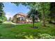 Spacious backyard featuring lush greenery, mature trees, manicured landscaping and an inviting patio area at 1010 Mill Pointe Way, Elon, NC 27244