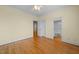 Bedroom with hardwood floors, ceiling fan, and ensuite bathroom entrance at 1010 Mill Pointe Way, Elon, NC 27244