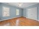 Comfortable bedroom with hardwood flooring, two windows, and a ceiling fan at 1010 Mill Pointe Way, Elon, NC 27244