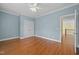 Bedroom with light blue walls, hardwood flooring, closet and view to the landing at 1010 Mill Pointe Way, Elon, NC 27244
