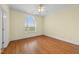 A bright bedroom featuring hardwood floors and a large window for natural light at 1010 Mill Pointe Way, Elon, NC 27244