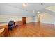 Bonus room featuring hardwood floors, built-in desk and ceiling fan at 1010 Mill Pointe Way, Elon, NC 27244