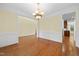 Spacious dining room featuring hardwood floors, elegant chandelier, and classic wainscoting at 1010 Mill Pointe Way, Elon, NC 27244