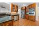 Open kitchen with stainless steel appliances, dark countertops and wooden cabinets at 1010 Mill Pointe Way, Elon, NC 27244