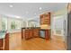 Open kitchen with wooden cabinetry, stainless steel appliances, and hardwood floors at 1010 Mill Pointe Way, Elon, NC 27244